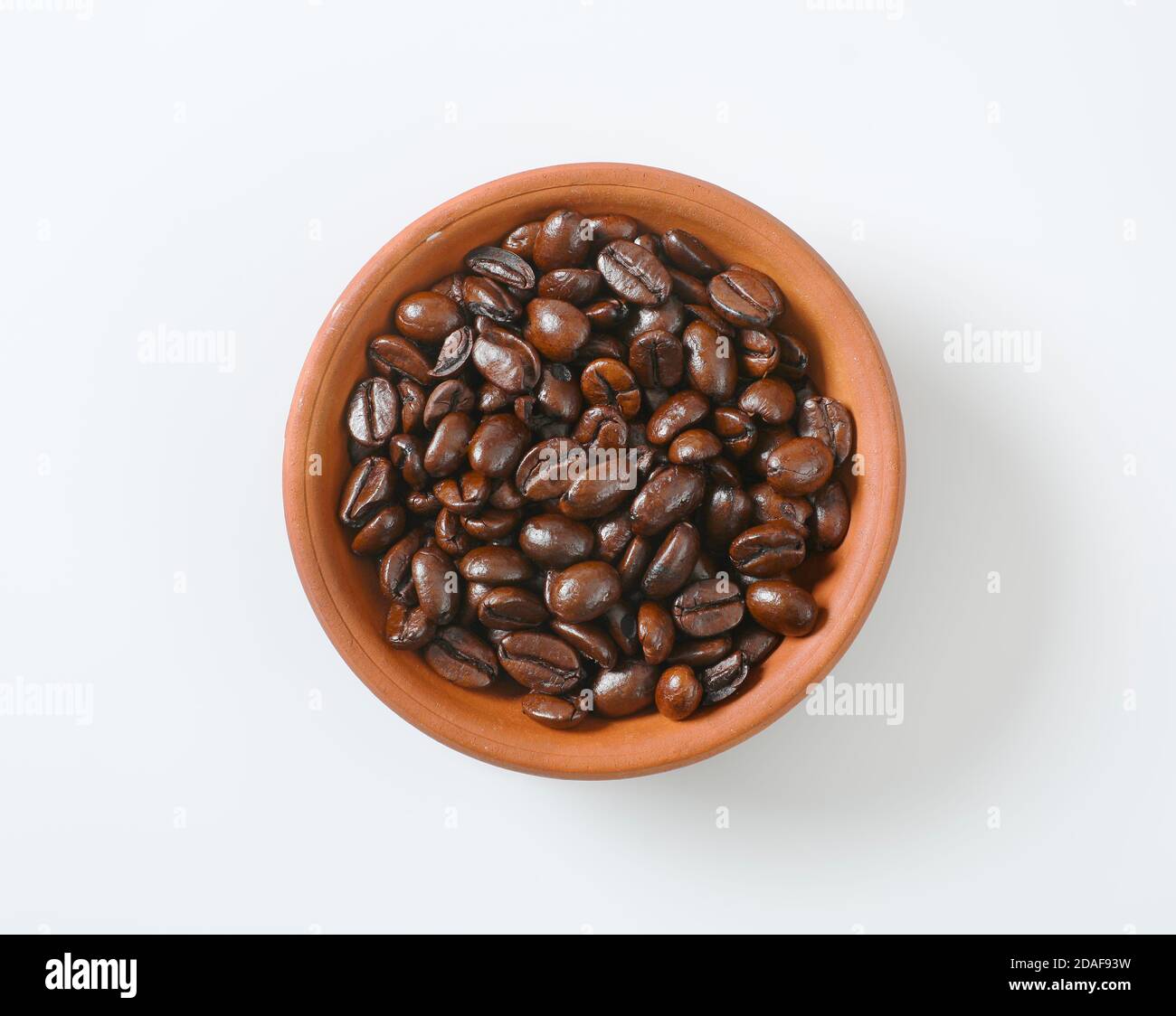 Roasted coffee beans in terracotta bowl Stock Photo