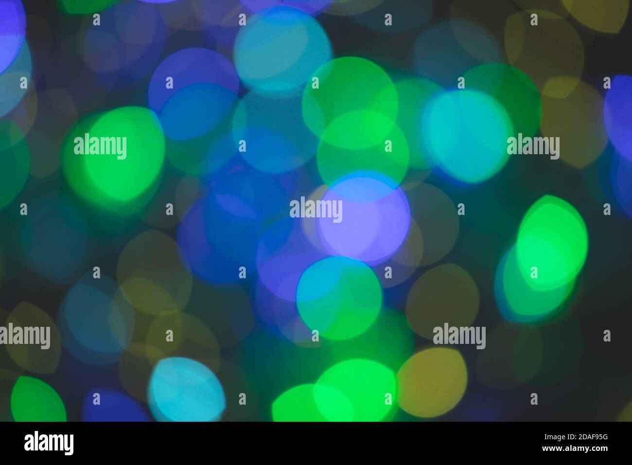 Multicolored spots of light against black background Stock Photo
