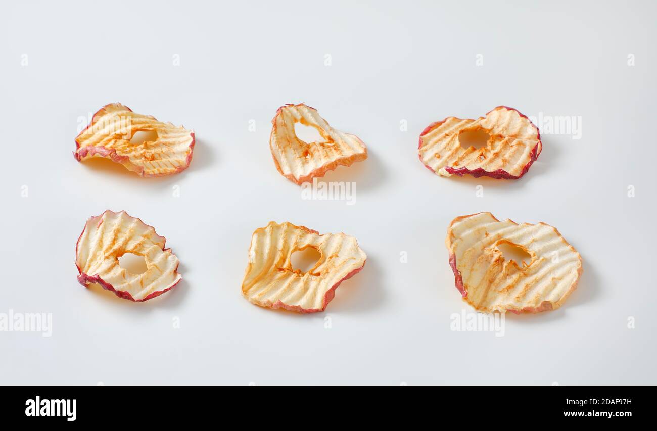 Six apple chips (dried thin apple slices) Stock Photo
