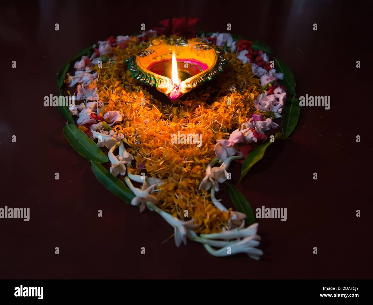 Diya or lamps along with floral decorations for the occasion of Diwali Stock Photo