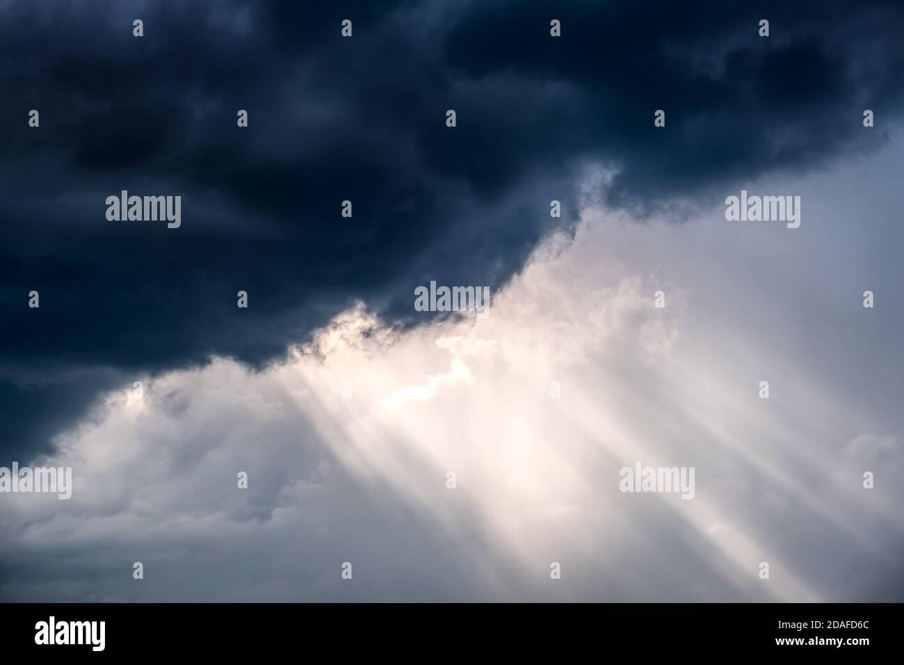 Light in the Dark and Dramatic Storm Clouds Stock Photo