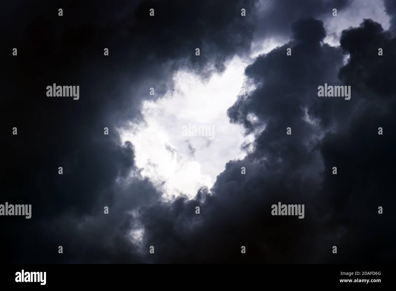 Hole in the Dark and Dramatic Storm Clouds Stock Photo