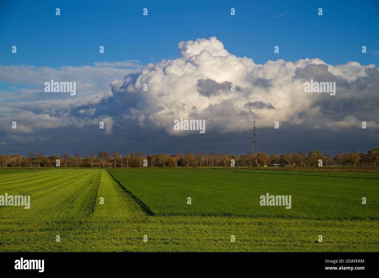 Weather front approaching over dull, modern, flat production landscape Stock Photo