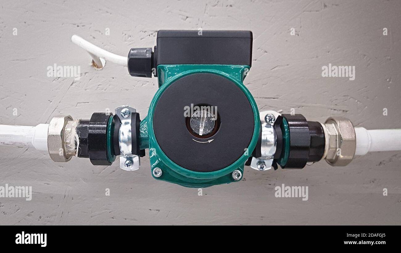 Green heating circulation pump mounted on a pipe Stock Photo Alamy