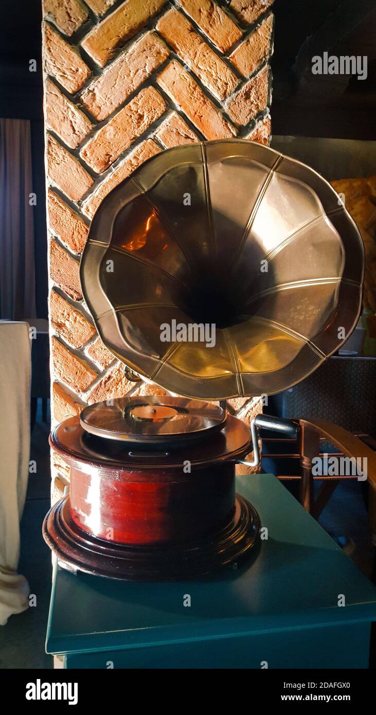 Gramophone with plate or vinyl disk. Antique brass record player