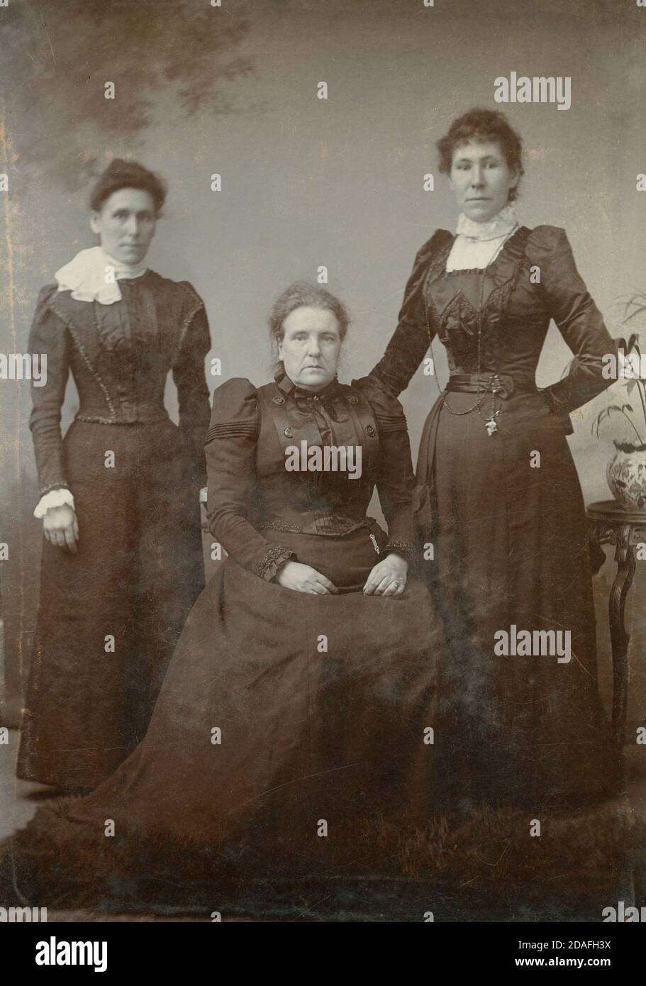 Antique c1880 photograph, three Victorian women, perhaps mother and daughters, in mourning. SOURCE: ORIGINAL CABINET CARD Stock Photo