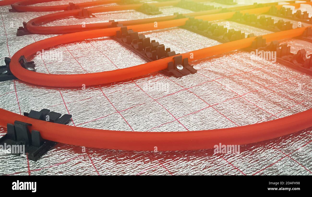 Underfloor heating pipe. Installation of engineering systems in a building. Lens glare Stock Photo
