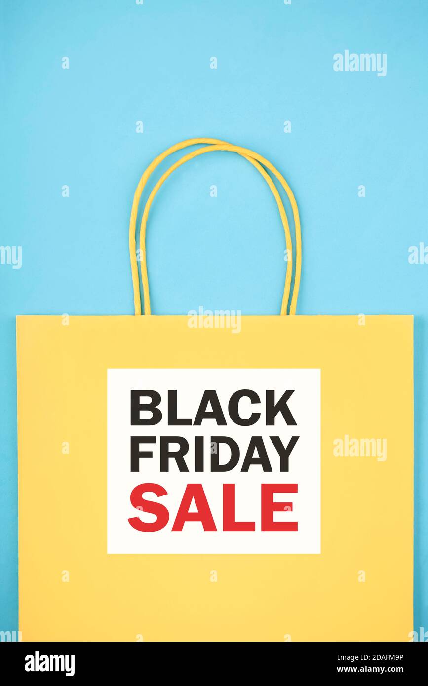 Black friday.Yellow shopping bag with text on yellow background.Shopping concept Stock Photo