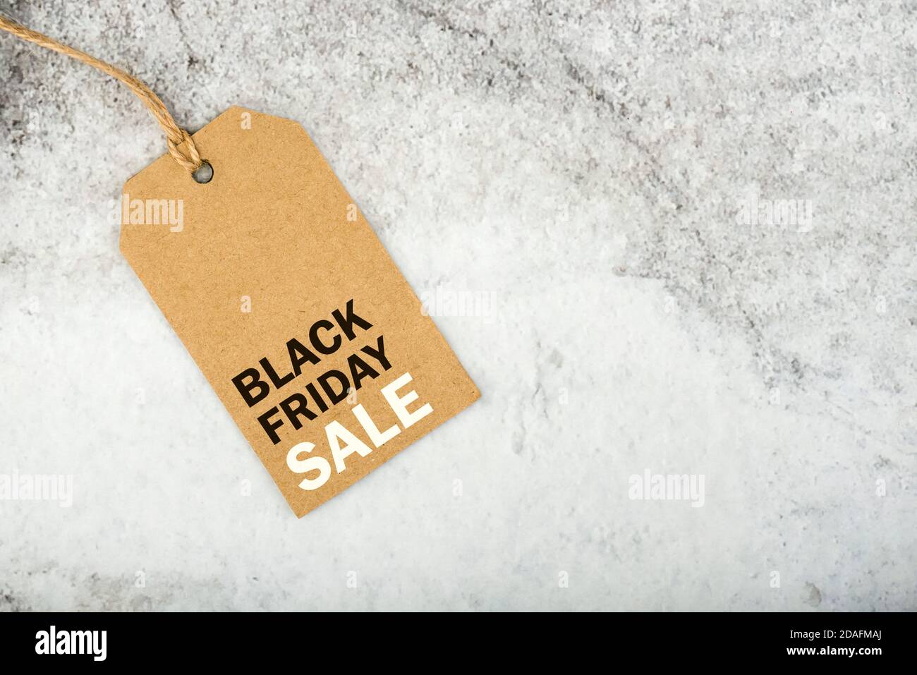 Black friday.Brown sale tag with text on gray background.Shopping concept Stock Photo