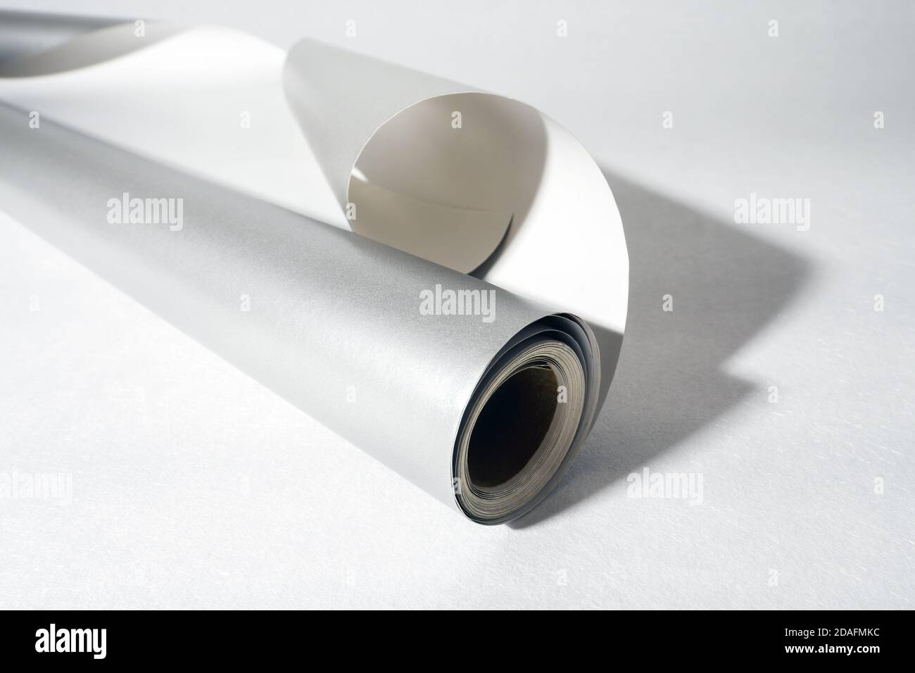 Side view of gray roll paper on white background, selective focus Stock Photo
