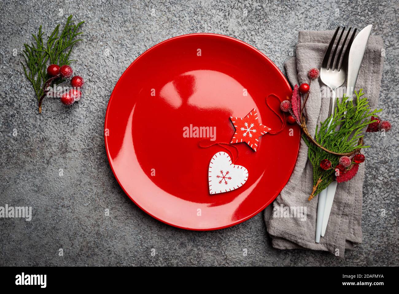 Christmas table setting with christmas decorations on gray background. Top view, copyspace. Stock Photo