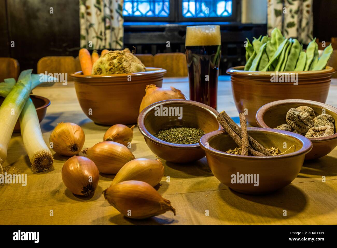 Vegetables, spices and smoked beer from Bamberg. The smoked beer can also be used as a seasoning. Basic ingredients for the first course of the medieval menu at Gasthof Schlenkerla. 'Ein spise von bonen und spec vigen“ (untranslated Old High German) Bamberg, Germany Stock Photo