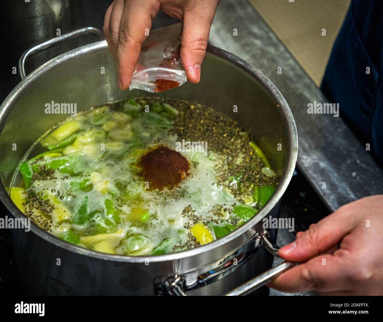 Simon Klein preparing the bean soup with smoked beer, saffron and savory in Bamberg, Germany Stock Photo