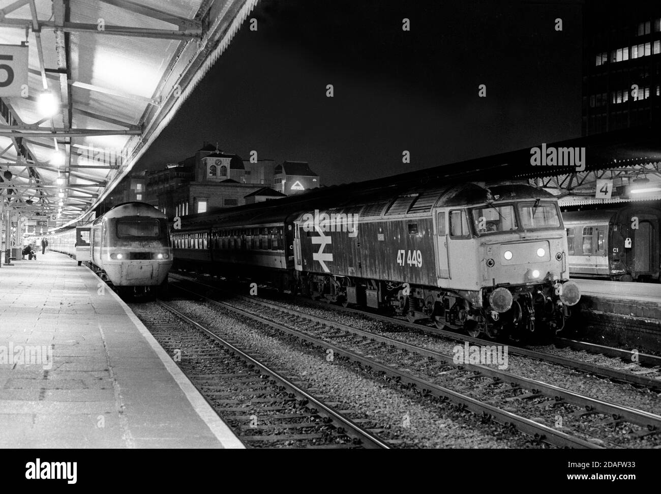 A Class 47 diesel locomotive number 47449 and an HST stand at Reading station on the evening of the 19th October 1991. Stock Photo