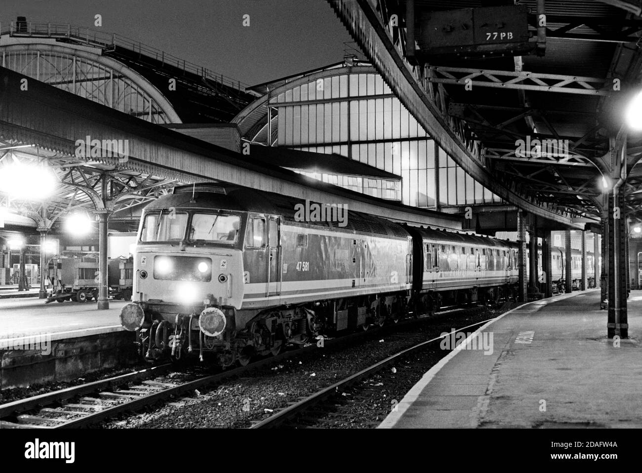 A Class 47 diesel locomotive number 47581 waits to depart from London Paddington station on the evening of the 16th November 1991. Stock Photo