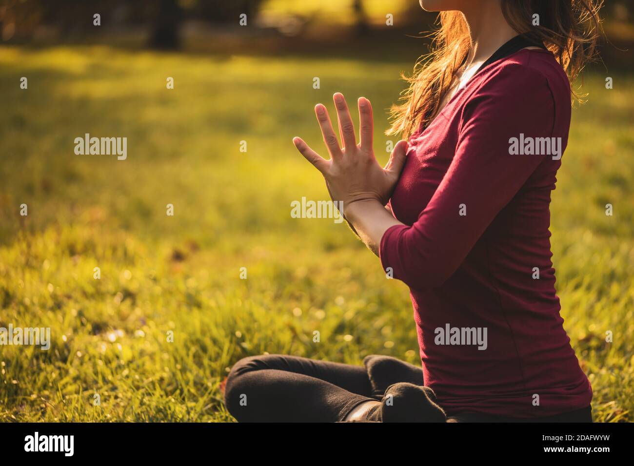 Close Up Image Of Woman Sitting In Lotus Position And Meditating