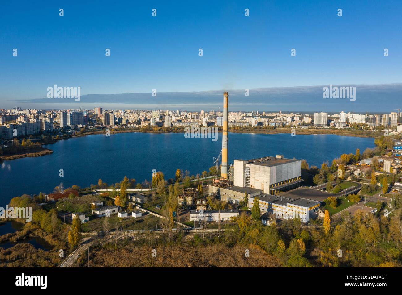 Waste incineration plant in the city near the lake. Stock Photo