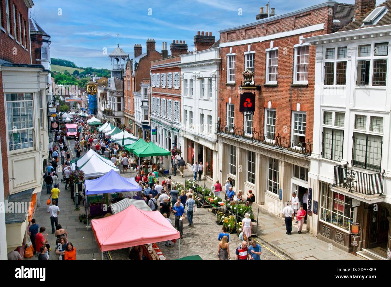 GUILDFORD Alfresco market food stalls Guildford high street market in historic high street with shoppers on a summer market day Guildford Surrey UK Stock Photo