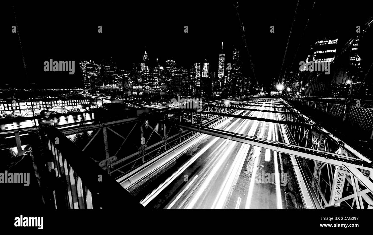 Brooklyn Bridge Traffic lights lines trails at night New York, USA, long exposure time, Slow Shutter, black and white. Stock Photo