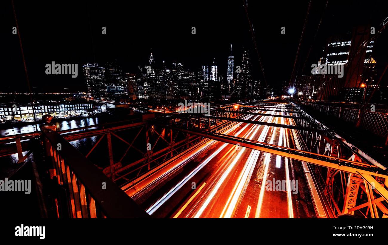 Brooklyn Bridge Traffic lights lines trails at night New York, USA, long exposure time, Slow Shutter. Stock Photo