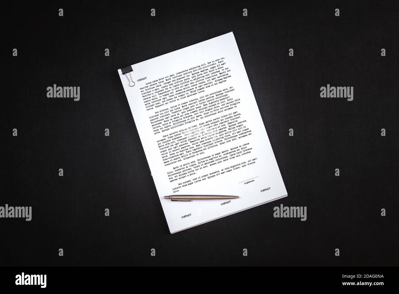 Picture of thick contract with dummy text and ball point pen to sign it. Stock Photo