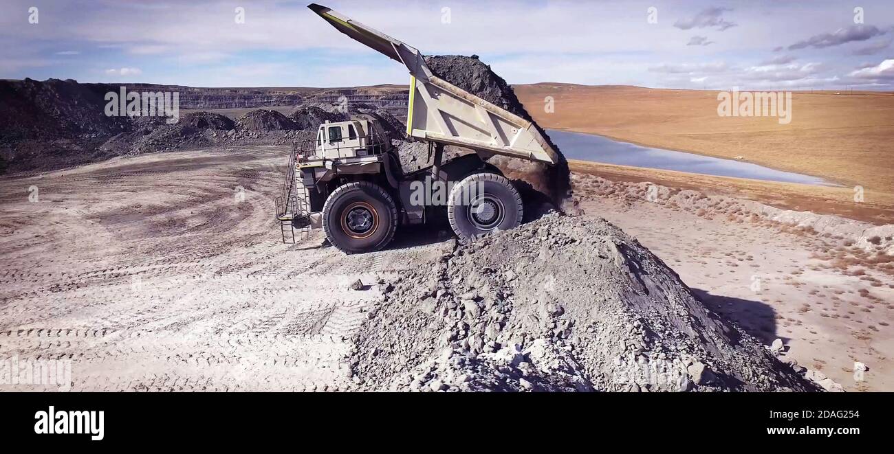 Haul truck unloading soil in the quarry Stock Photo