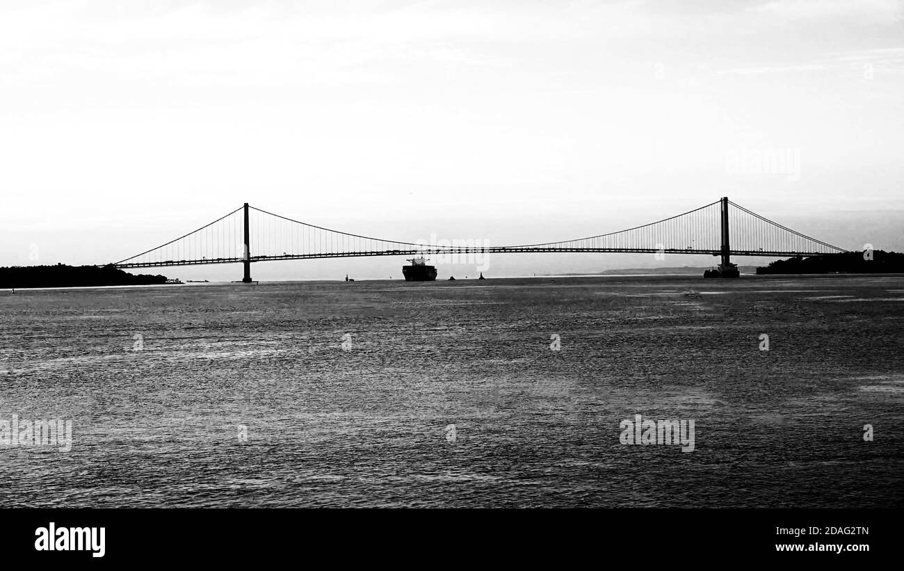 ship passing under the Golden Gate Bridge in San Francisco, black and white Stock Photo