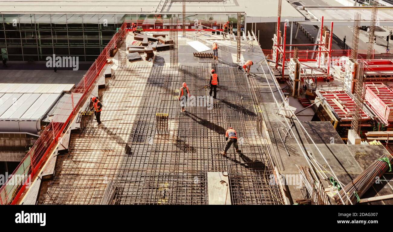 Top view of workers while fixing grid foundation bars in construction
