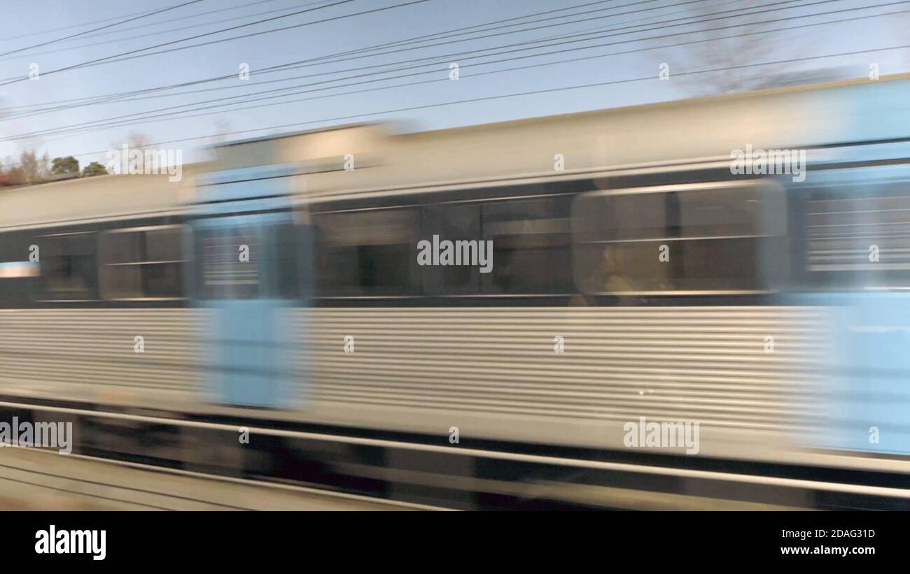 Moving Tram trail on the railroad, High speed train in motion at the railway, with motion blur effect. Long exposure background Stock Photo
