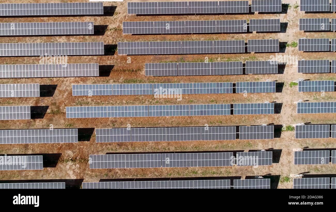aerial view of solar power panels, in desert during a sunny day. Stock Photo