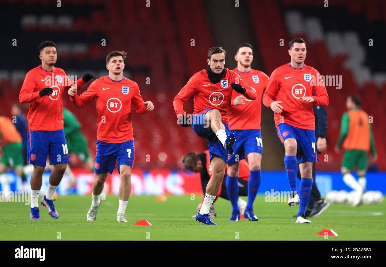 England's Harry Winks (centre) and team-mates warm up before the international friendly at Wembley Stadium, London. Stock Photo