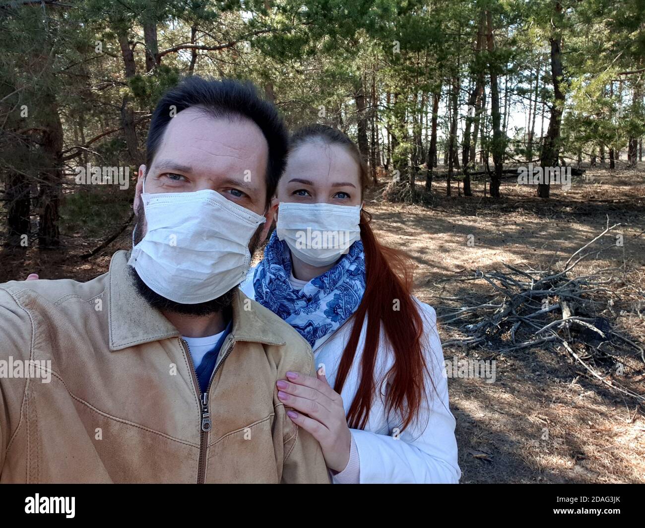 a couple in love in a medical mask takes a selfie on a smartphone Stock ...