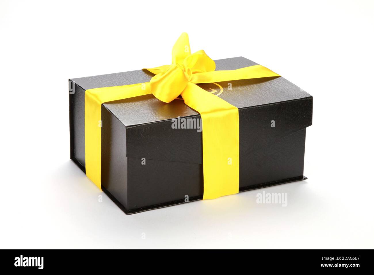 Premium Photo  Black gift with a beige ribbon on a yellow background. view  from above.