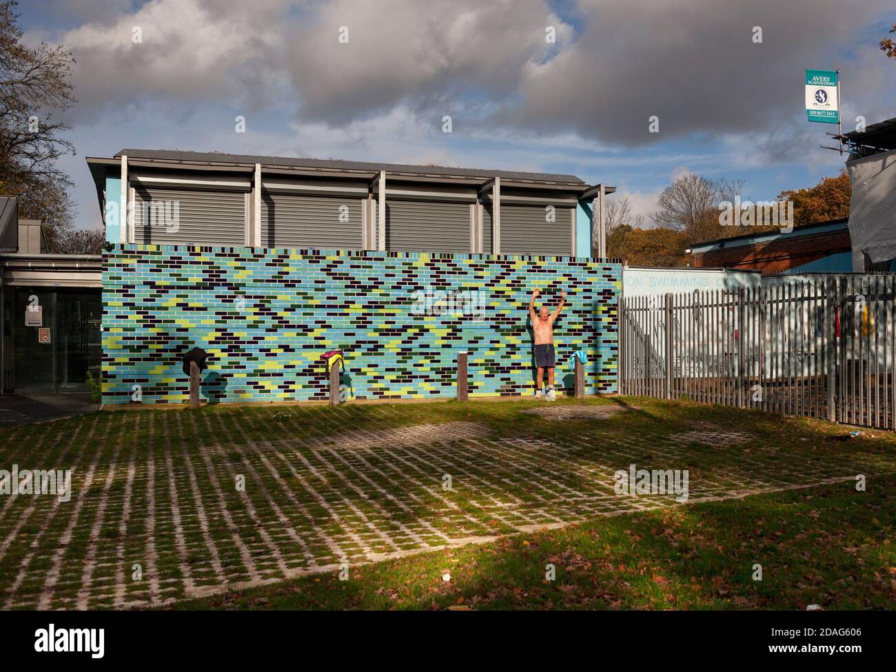 A male bare chested septuagenarian exercises in front of the A male bare chested septuagenarian exercises in front of the