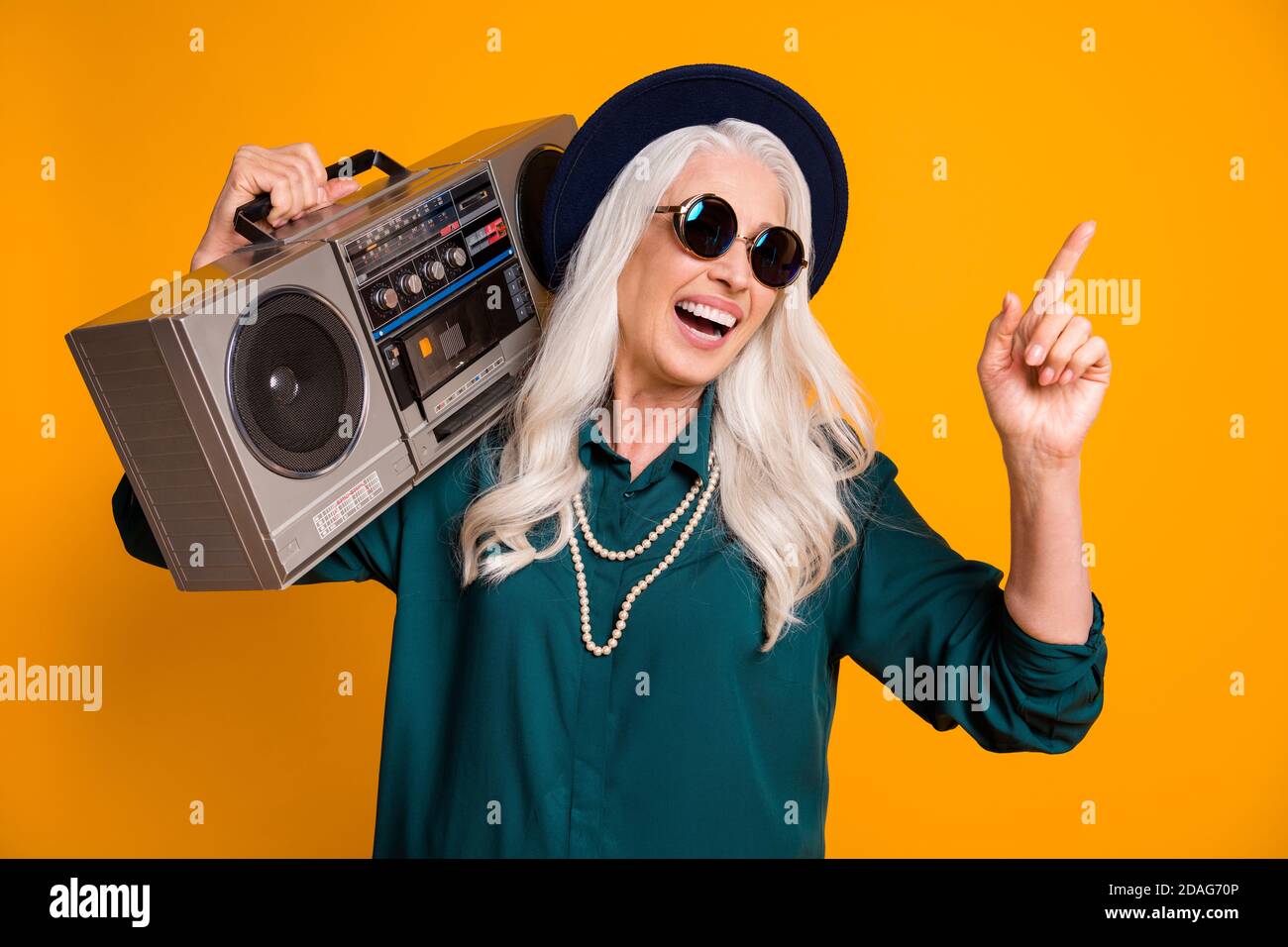 Photo of crazy cool granny lady music lover senior party tape recorder  shoulder direct finger empty space wear green shirt sun specs necklace  retro Stock Photo - Alamy