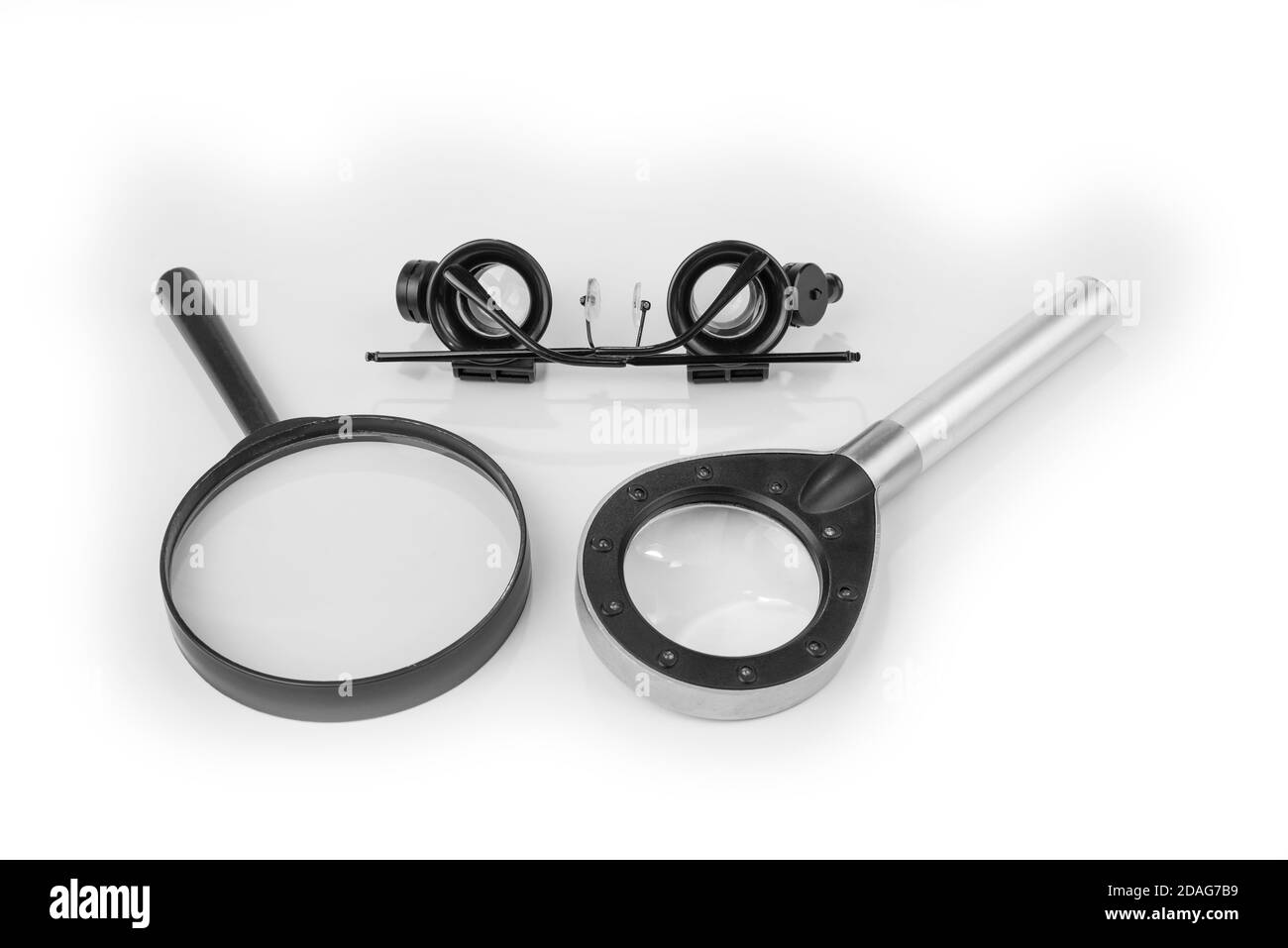 Magnifying glass and goggles glasses on a white Stock Photo