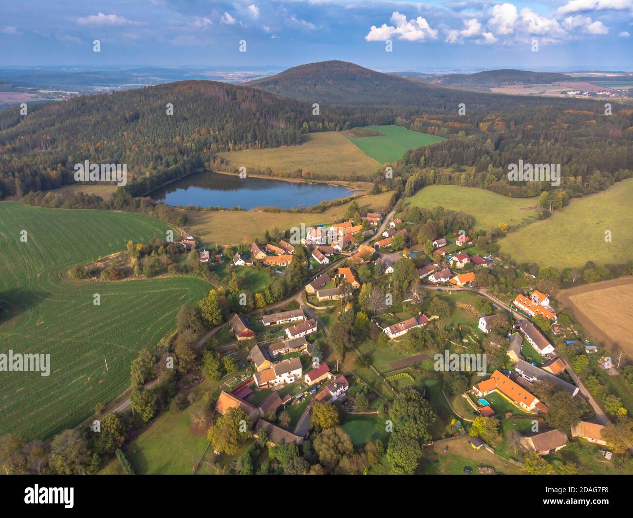 Aerial view of a small village hills in background.Top view of traditional housing estate in Czech.Houses from above, real estate concept.Countryside Stock Photo