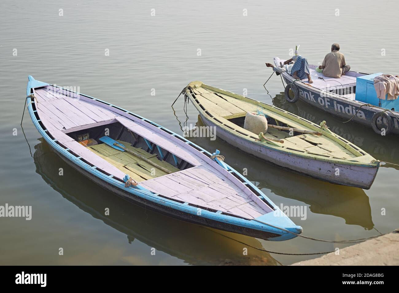 Varanasi, India, December 2015. A man sitting in a boat on the Ganges River. Stock Photo