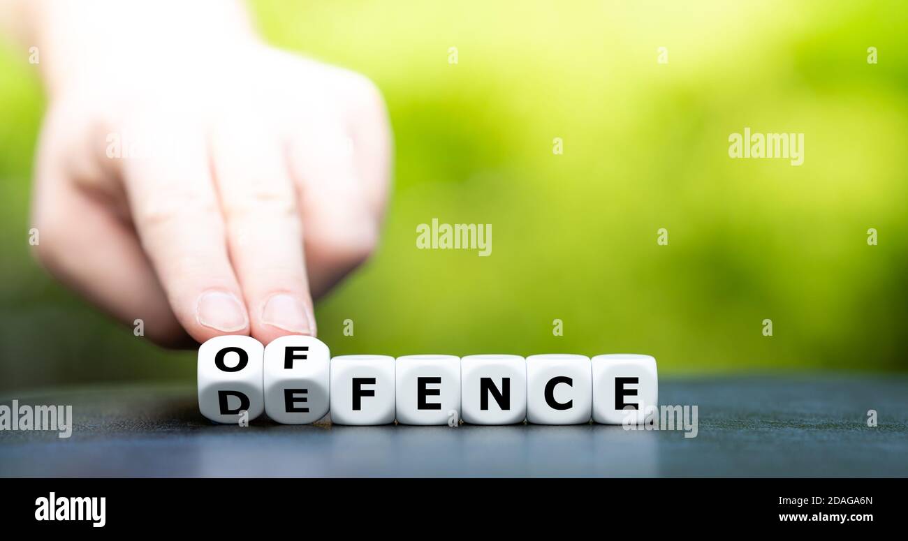 Dice form the words offence and defence. Stock Photo