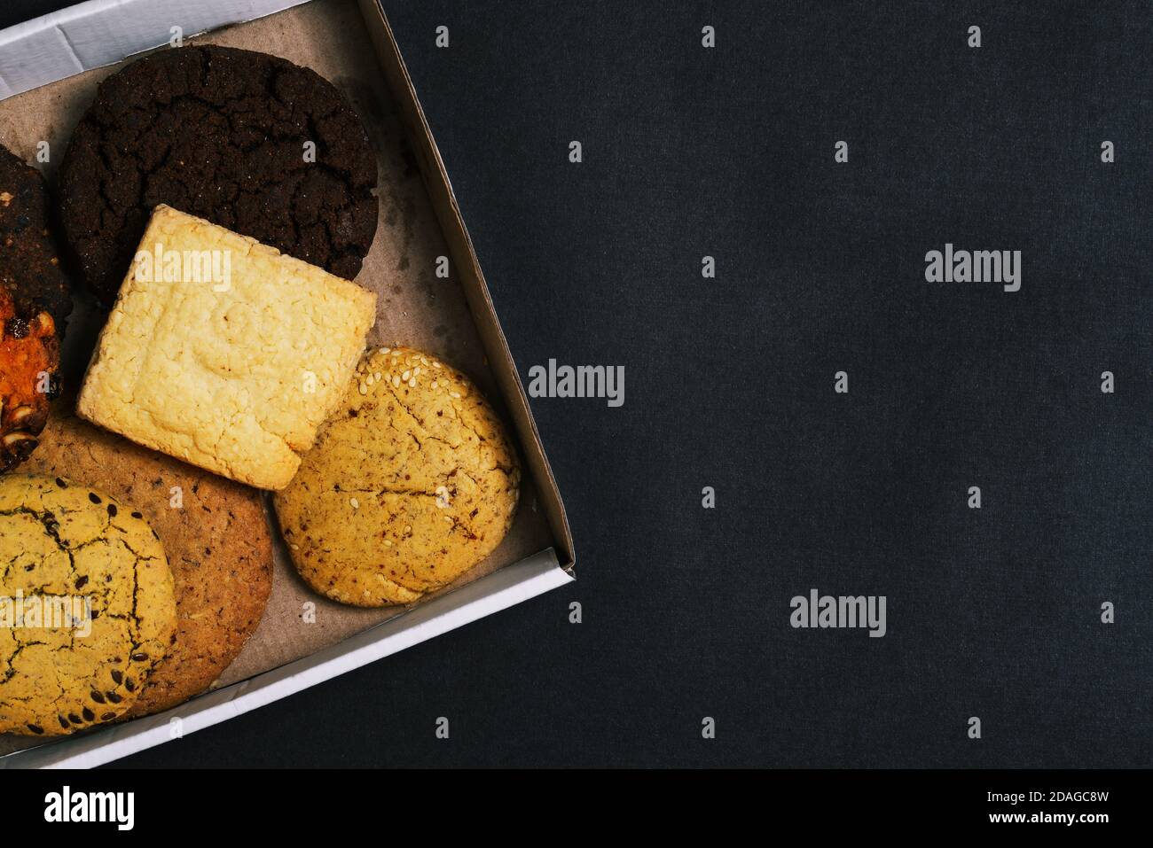 Sweet food. Homemade cakes of different types are packed in a cardboard box. Close-up of pastry baked goods with copy space Stock Photo
