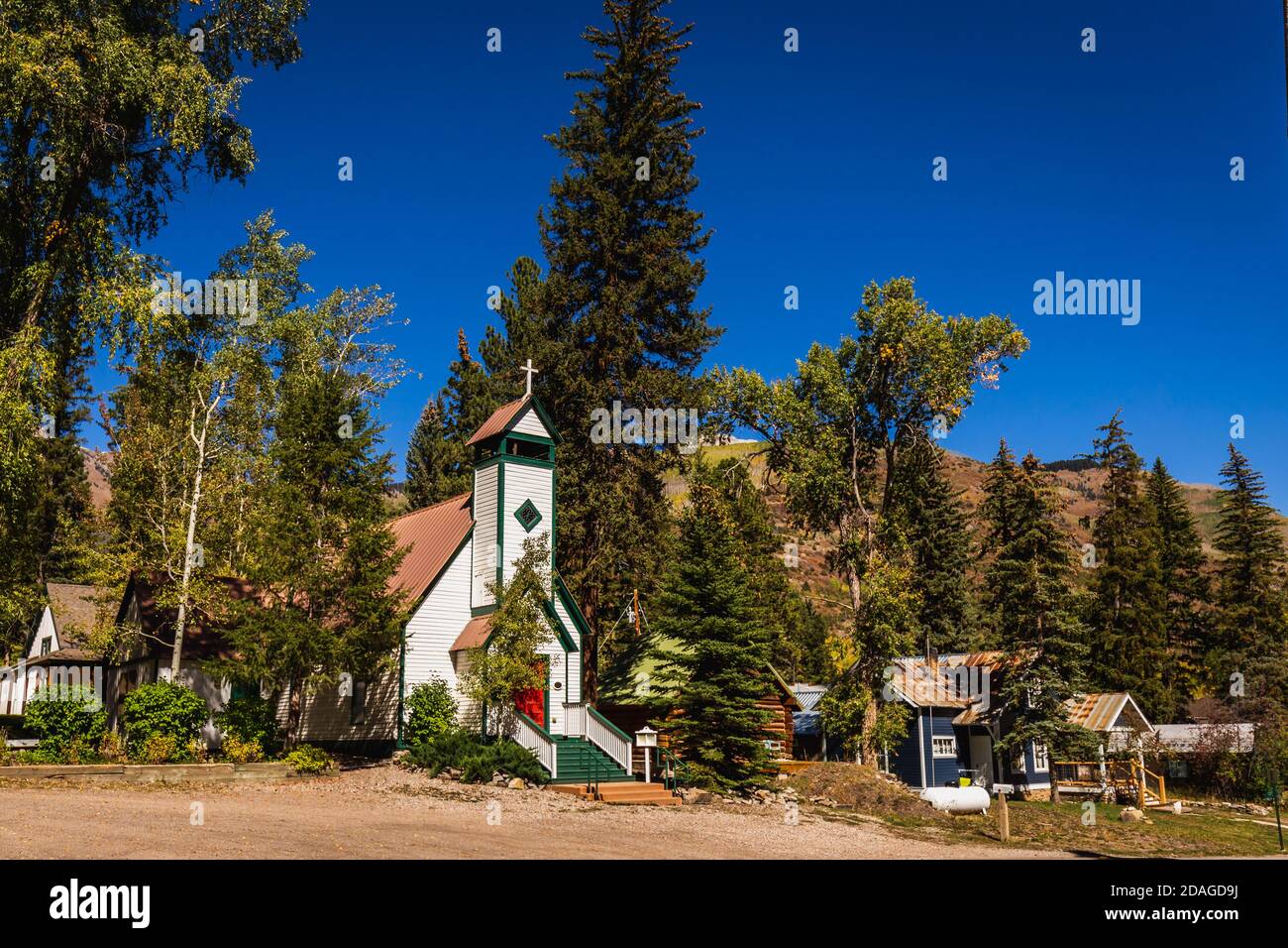 Church with beautiful yellow autumn aspen tree leaves at the background. Taken in Black Hawk city turned into gambling destination of Colorado Rocky M Stock Photo