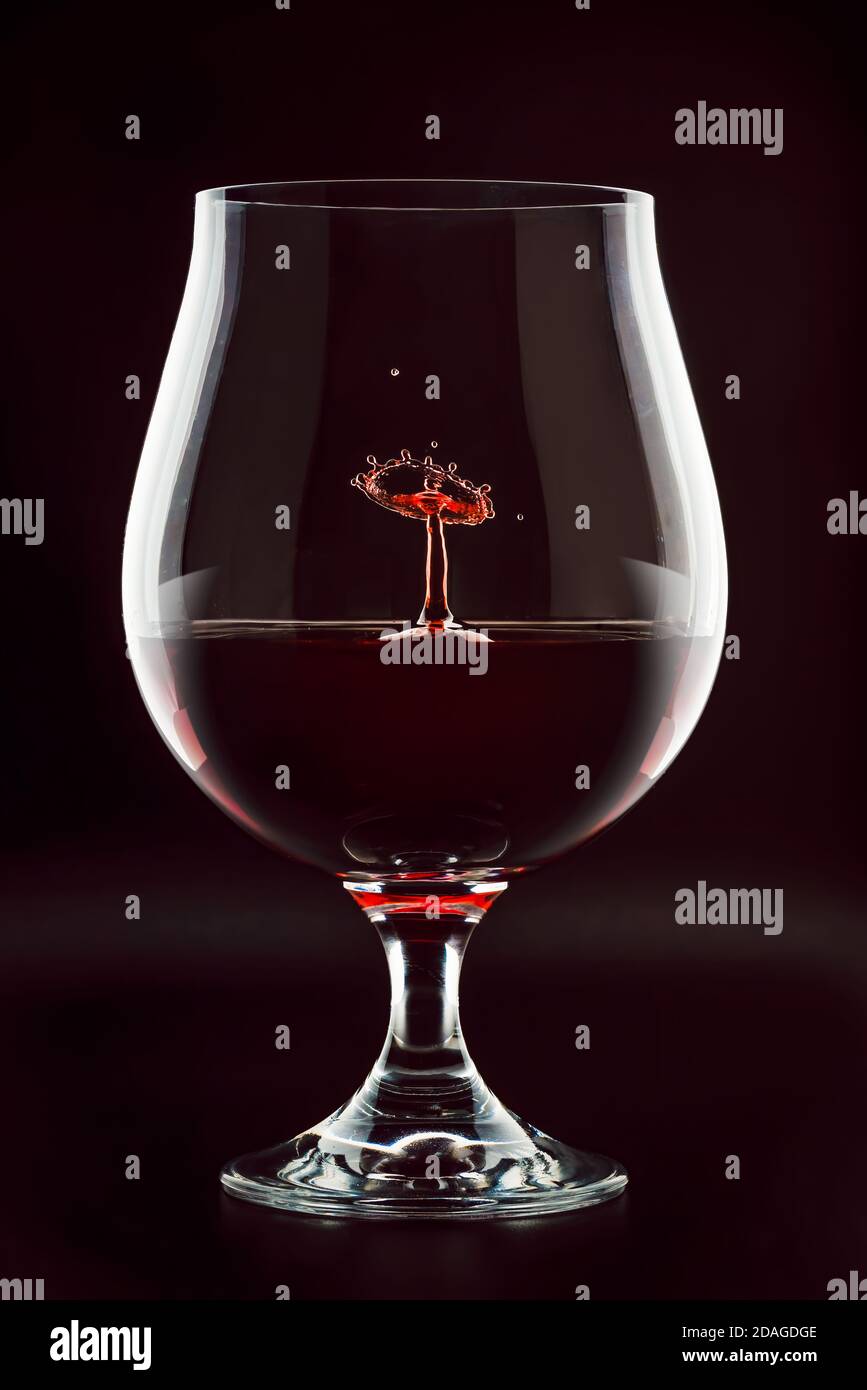 Red wine drop splashing inside glass close up Stock Photo Alamy