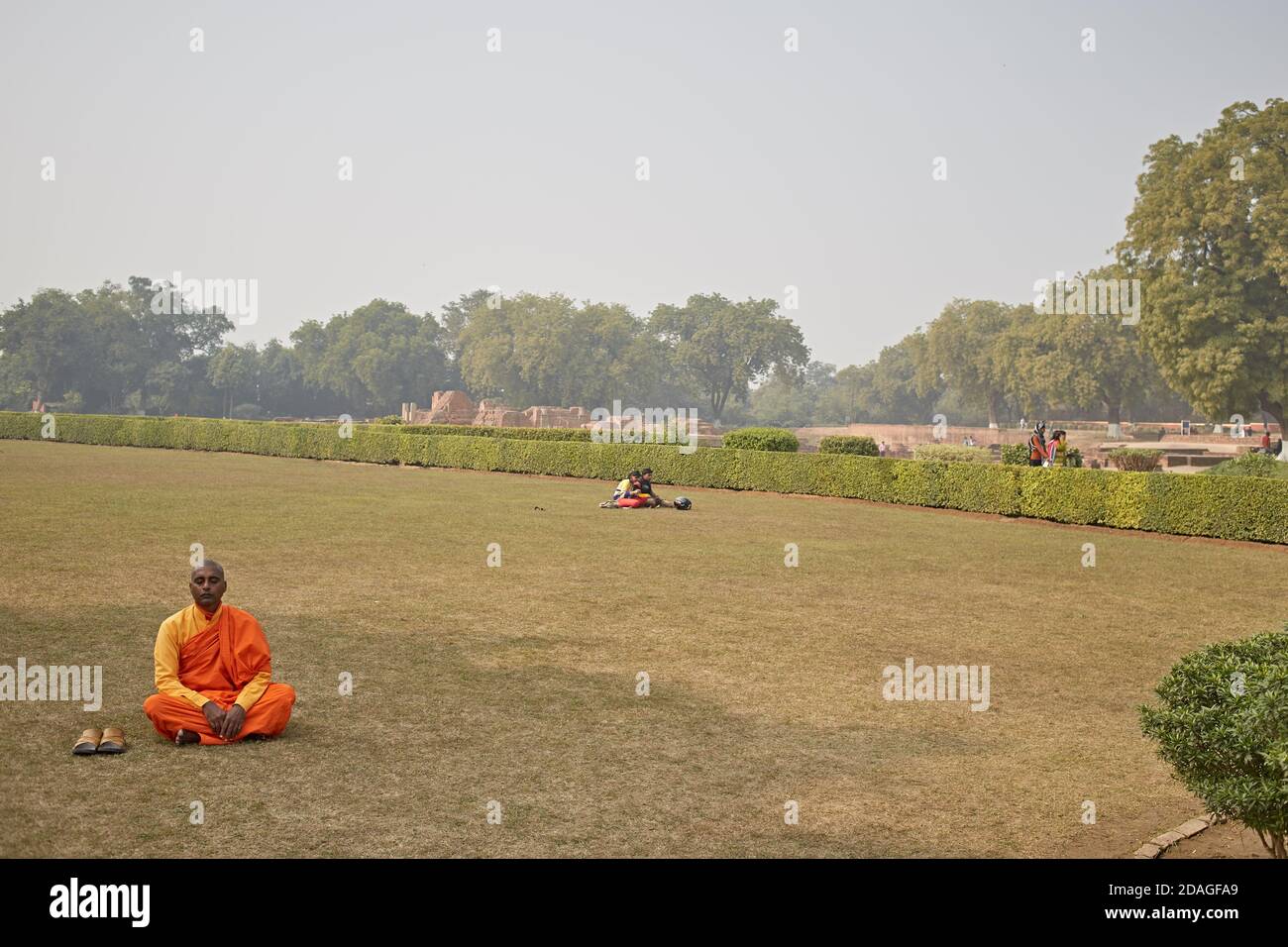 Varanasi, India, January 2016. A Buddhist monk praying in a garden in Sarnath. Stock Photo