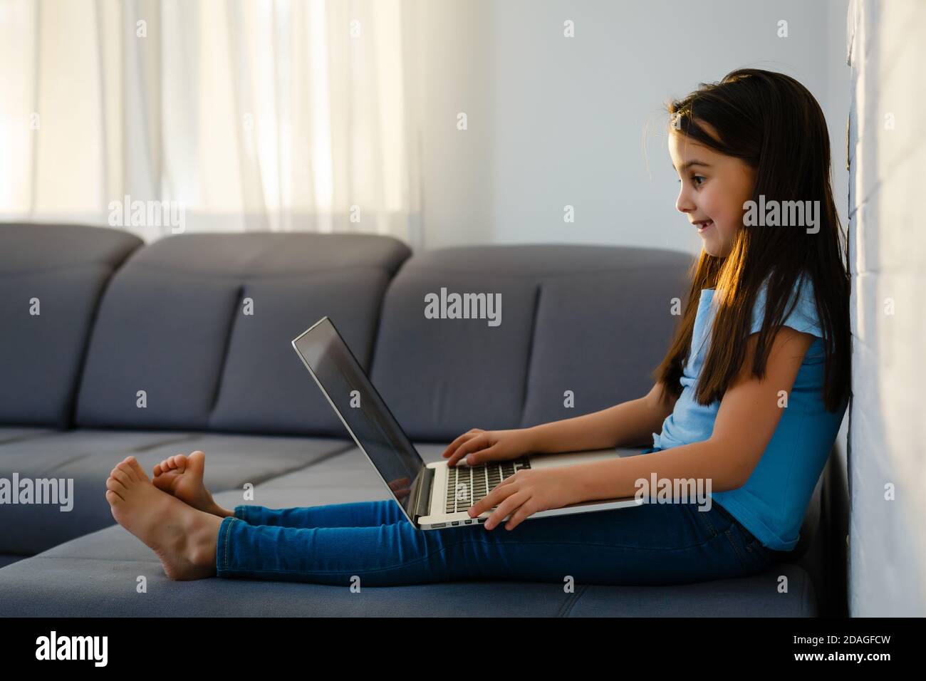 little girl studying with computer Stock Photo - Alamy