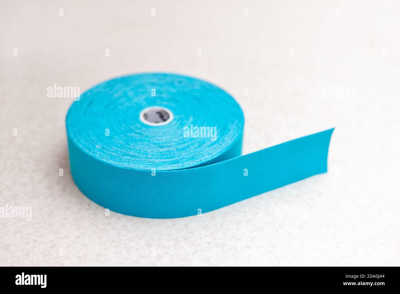 Blue adhesive elastic therapeutic kinesio tape on lying on table at