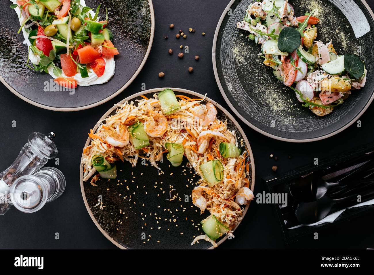 Asian vegetable salad with shrimp on a black background Stock Photo