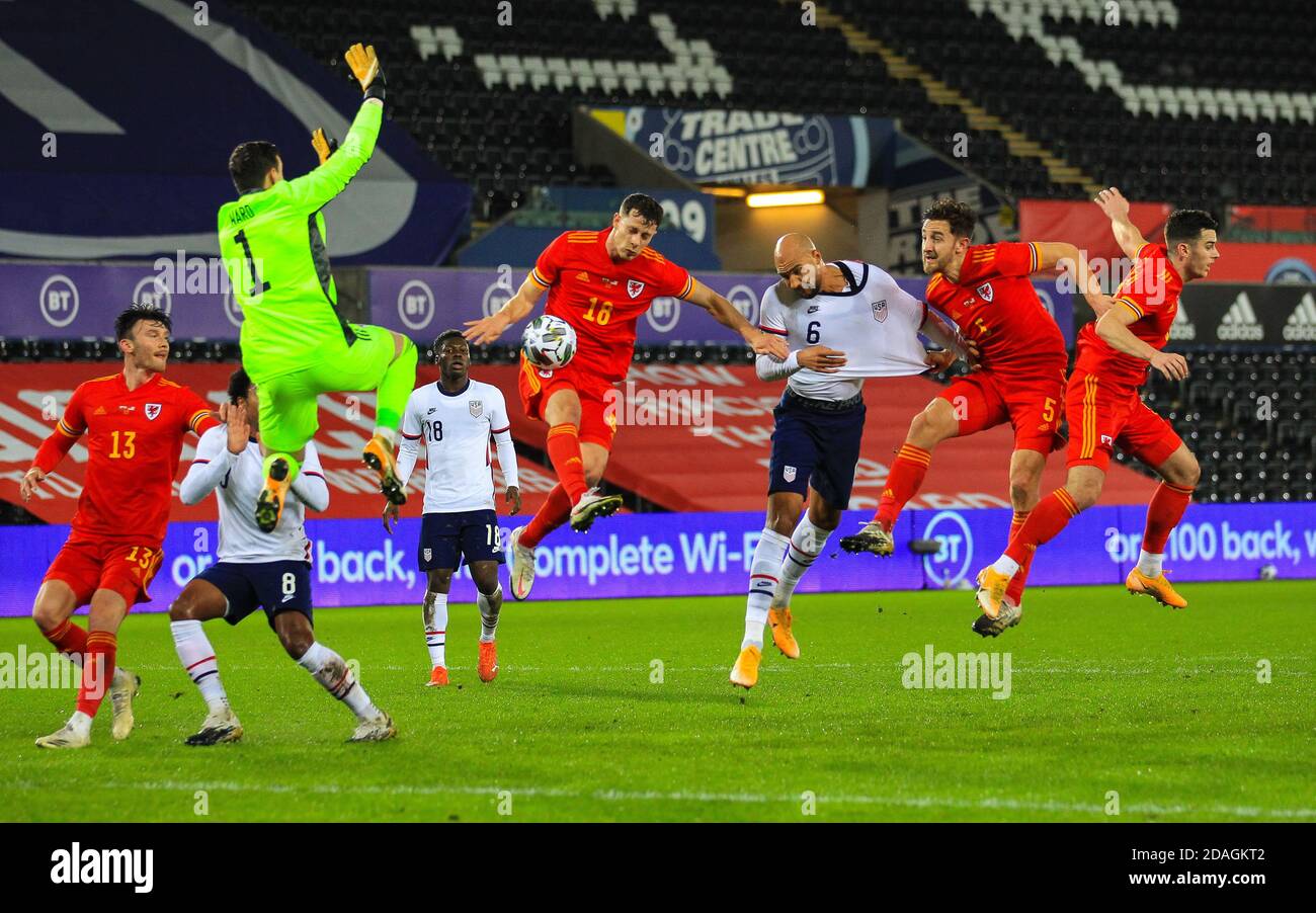 Liberty Stadium, Swansea, Glamorgan, UK. 12th Nov, 2020. International Football Friendly; Wales versus United States of America; John Brooks of USA heads at goal while under pressure from Tom Lockyer and James Lawrence of Wales as Keeper Ward comes out to save Credit: Action Plus Sports/Alamy Live News Stock Photo