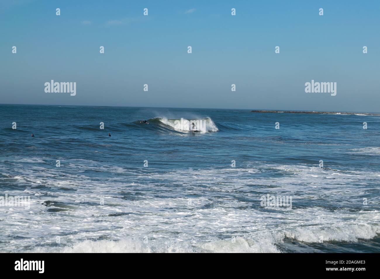 Surf Session in Ofir Beach at Portugal in November with longboard surfer  catching a wave Stock Photo - Alamy