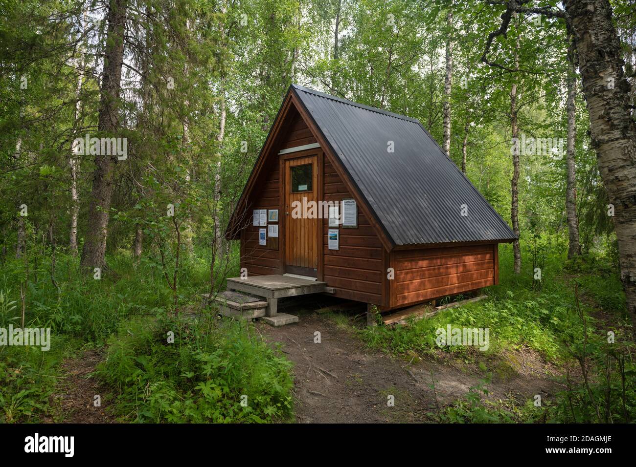 Small shelter in forest at southern trailhead of Padjelantaleden trail, Lapland, Sweden Stock Photo