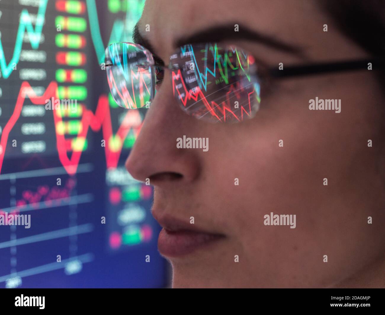 Financial trader analysing stock market data on computer screen. Stock Photo